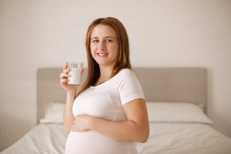 Pregnant woman drinks milkの写真素材
