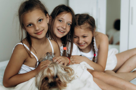 Family and friends concept. Three sisters wake up and smiling in the morningの写真素材