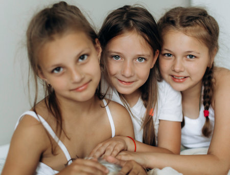Family and friends concept. Three sisters wake up and smiling in the morningの写真素材