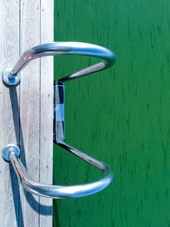 Blooming water in the lake. Handrails for launching into the waterの写真素材