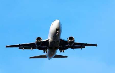 airplane landing on the blue sky backgroundの写真素材