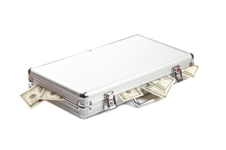 dollars money in the metall suitcase isolated over white backgroundの写真素材