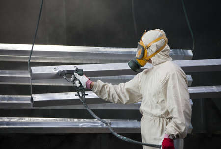 painter painting metal designs with airbrushの写真素材