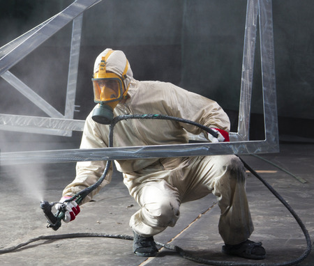 painter painting metal designs with airbrushの写真素材