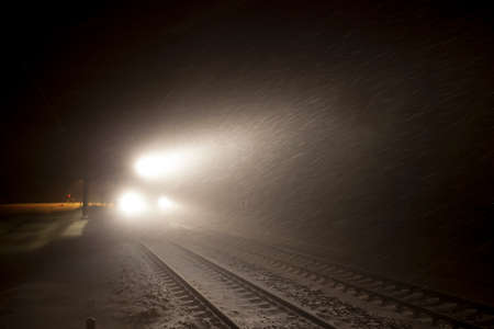 headlights of train in winter nightの写真素材