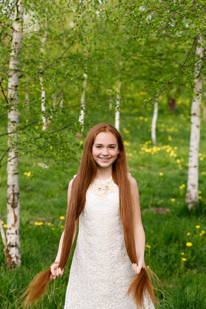 portrait of a beautiful red-haired girl in summerの写真素材
