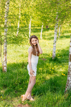 portrait of happy girl on nature in summerの写真素材