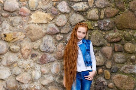 Portrait of beautiful smiling redhead with long hair girl with frecklesの写真素材