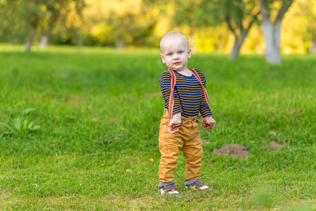 Cute little boy with big blue eyes in the park.の写真素材