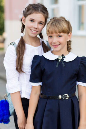 Schoolgirls in school uniform rest on a break near the school. School dayの写真素材