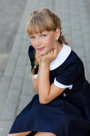 Portrait of a beautiful girl in a school uniform before class at school. School styleの写真素材