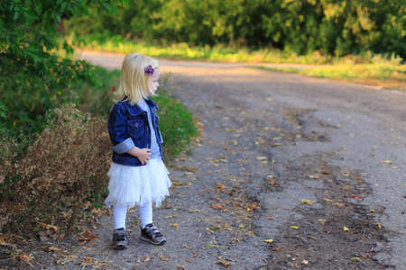 Portrait of a beautiful blonde girl outdoors in summerの写真素材