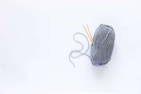 Many gray balls of thread on a white background.