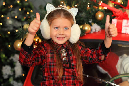 Happy little girl on the background of New Years decor.の写真素材