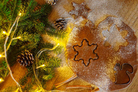 Rolled dough for gingerbread on a background of silt and garlands.