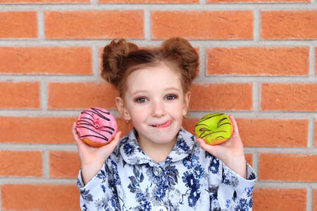 portrait of a child with a donut in his hands