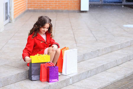 A girl with a lot of packages in her hands.の写真素材