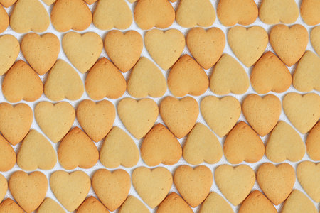 background made up of an array of heart-shaped cookies, perfectly decorated for Valentines Dayの写真素材