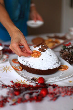 an exquisitely set Christmas table, adorned with elegant decorations and a delightful festive pie as the centerpieceの写真素材