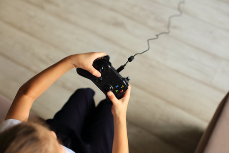 A close-up shot of hands gripping a game controller, showcasing the excitement and intensity of...