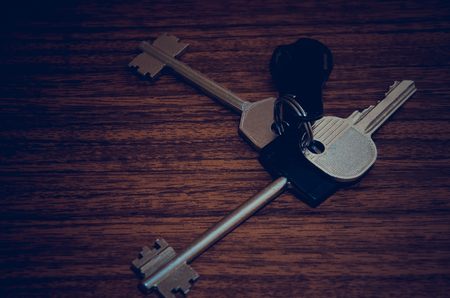 The keys to the apartment on the table. Casually bloomed bundle of cuceae. Object key, Iron keys for mechanical lock.の写真素材