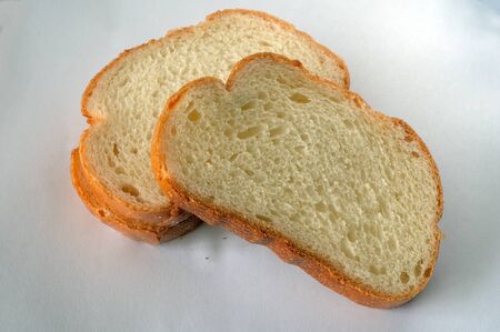 Sliced pieces of bread. Bread production. Fresh bread. Slices on a light background. Bakery baking....