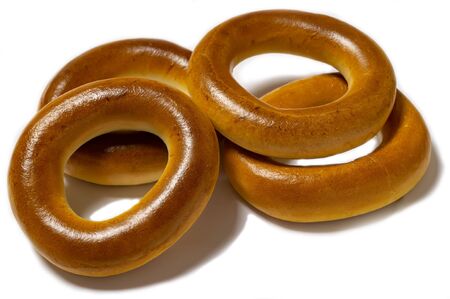 Bagels on a white background. Bakery products. Junk food. Fresh bakery. Tea Products. Golden...