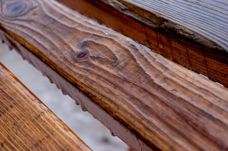 Wooden blocks on the street in rainy weather with raindrops. embossed wooden bars on a rainy dayの写真素材