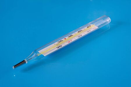 Medical thermometer on a blue background close-up