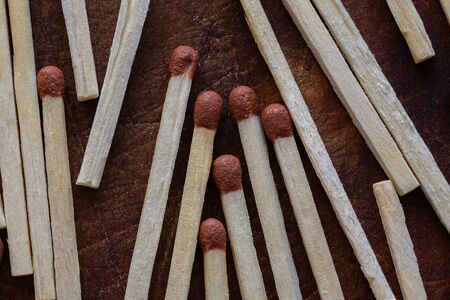 Scattered matches close-up on a dark wooden background top view