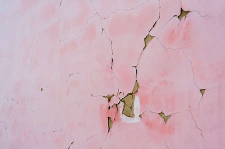 Pink background cracked plaster abstraction in soft focus