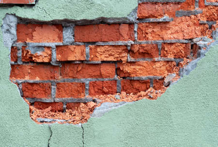 abstract background fragment of a brick wall in need of repair. a fragment of a building in need of...