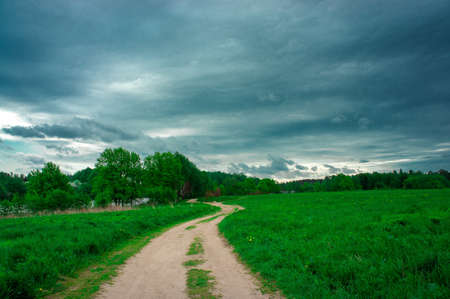 green landscape of field space in anticipation of a thunderstormの写真素材
