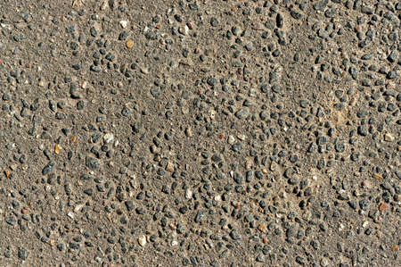 background rough texture concrete wall interspersed with rubble hard uniform lightの写真素材