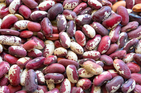 red beans striped scattered on a plane close-up top viewの写真素材