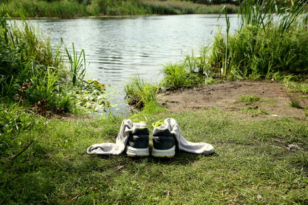 shoes with socks on the coast of the lakeの写真素材