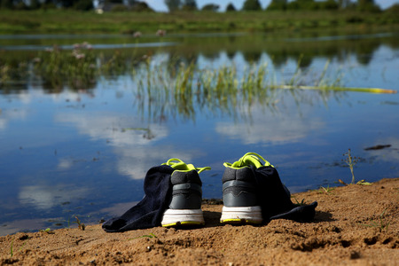 Sneakers with socks nesr waterの写真素材