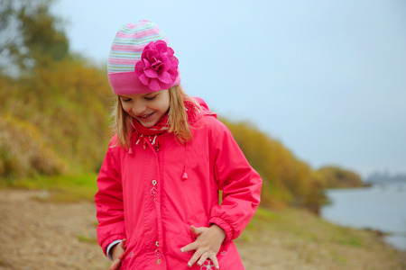 The smiling little girl in rose jacketの写真素材