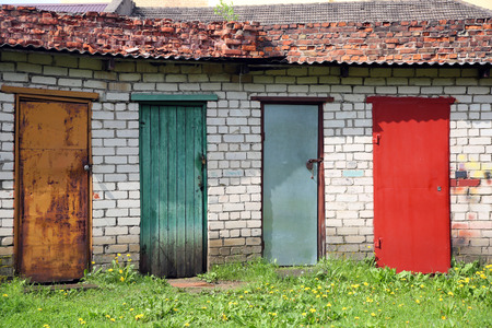 Row of colored doors - red, yellow, blue, green. Outdoorの写真素材
