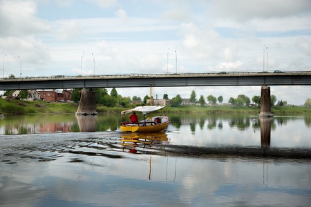 Yellow boat with sailor on the boardの写真素材