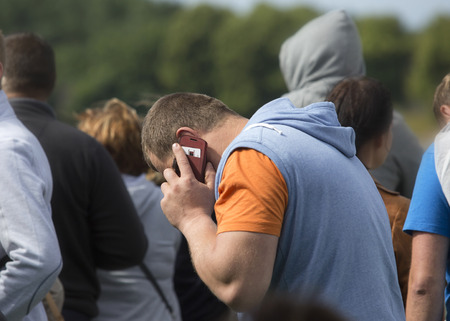 Man speaking on the phone a crowd of people
