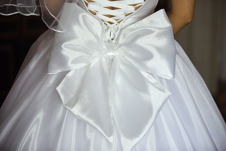 white bow on dress of bride from backの写真素材