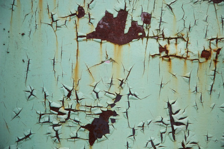 green scratched metal surface with peeling paintの写真素材