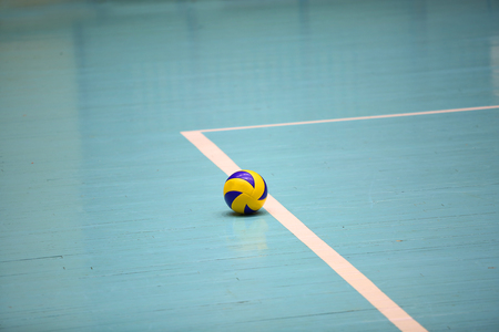 Volleyball ball on the floor of the hallの写真素材