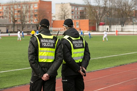 DAUGAVPILS, LATVIA - April 3, 2016: Municipal police keep order on the footbal match in Daugavpilsのeditorial素材