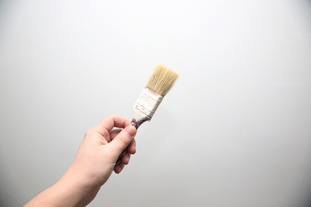 Man hold in the hand tools - paint brushの写真素材