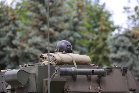 Soldier in helmet sitting in armored troop-carrierの写真素材
