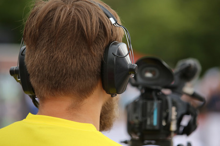 journalist in a row with video camera for tv reportageの写真素材