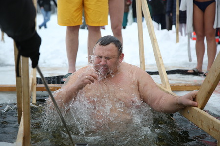 DAUGAVPILS, LATVIA - January 19, 2017: Orthodox church Holy Epiphany Day. People bathed in the ice-hole on Epiphanyのeditorial素材