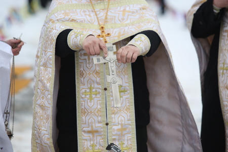 DAUGAVPILS, LATVIA - January 19, 2017: Orthodox church Holy Epiphany Day. Priest consecrates the ice hole on Epiphany dayのeditorial素材